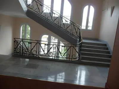 a spiral staircase in a building with windows at Residence Palais Miramar in Cannes