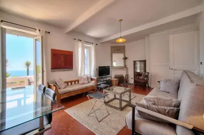 a living room with a couch and a table at Kathleen CANNES-GOLFE JUAN in Vallauris