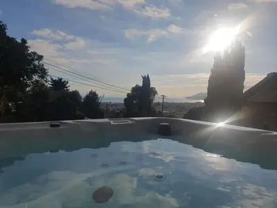 a hot tub in a backyard with the sun shining at chambre jaccuzi vue mer in Le Cannet