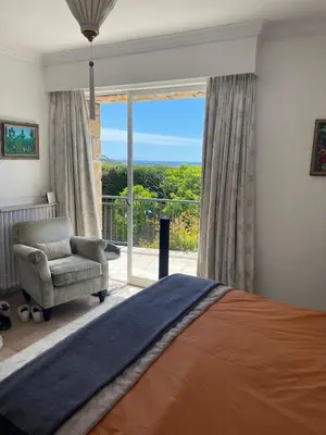 a bedroom with a bed and a chair and a window at Architect's house 100m2 sea view, terraces 35m2 in Le Cannet