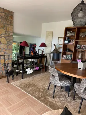 a living room with a table and chairs at Architect's house 100m2 sea view, terraces 35m2 in Le Cannet