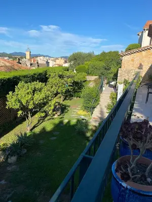 a balcony with a view of a yard with trees at Architect's house 100m2 sea view, terraces 35m2 in Le Cannet