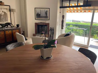 a dining room table with a potted plant on it at Architect's house 100m2 sea view, terraces 35m2 in Le Cannet