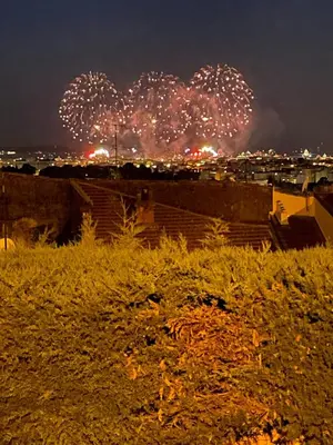 a firework display in the sky over a city at night at Architect's house 100m2 sea view, terraces 35m2 in Le Cannet