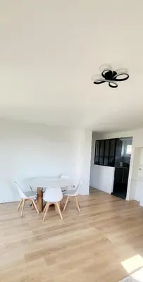 a dining room with a table and chairs and a ceiling fan at 3 pièces cocon dans les hauteurs de Cannes vue mer in Le Cannet