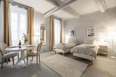 a bedroom with a bed and a table and chairs at Croisette Cannes 2 in Cannes