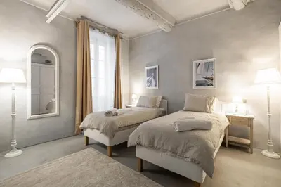 a bedroom with two beds and a window at Croisette Cannes 2 in Cannes
