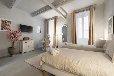 a bedroom with two beds and a desk in it at Croisette Cannes 2 in Cannes