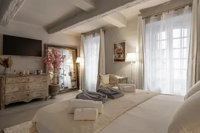 a large bedroom with a large bed and a tv at Croisette Cannes duplex in Cannes