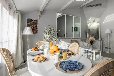 a dining room with a white table with food on it at Croisette Cannes duplex in Cannes