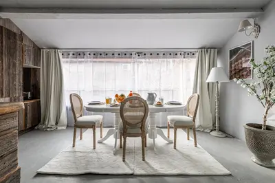a dining room with a white table and chairs at Croisette Cannes duplex in Cannes