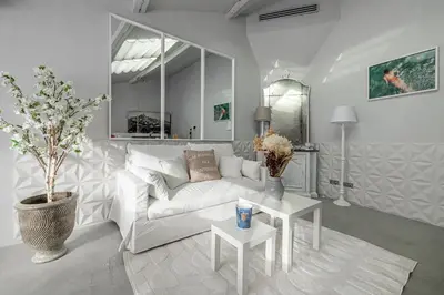 a living room with a white couch and a table at Croisette Cannes duplex in Cannes