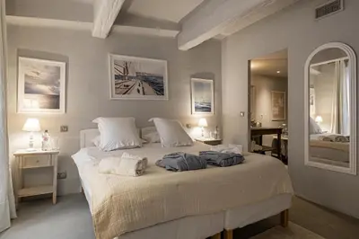 a bedroom with a large bed with towels on it at Croisette Cannes duplex in Cannes