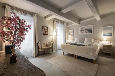 a bedroom with a bed and a large window at Hotel particulier Croisette in Cannes