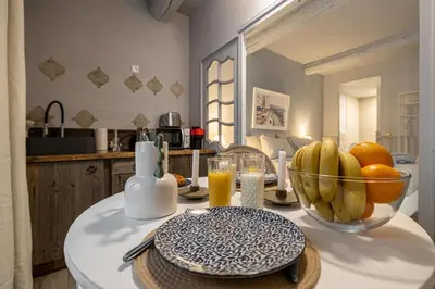 a kitchen with a bowl of fruit on a table at Hotel particulier Croisette in Cannes