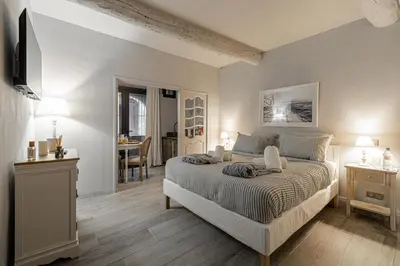 a bedroom with a bed and a table and a dining room at Hotel particulier Croisette in Cannes