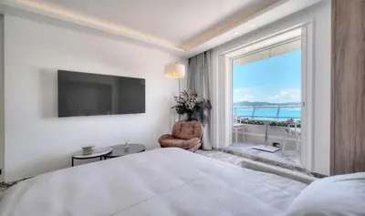 a bedroom with a large bed and a large window at Cannes 1 bedroom apartment - M6 in Cannes