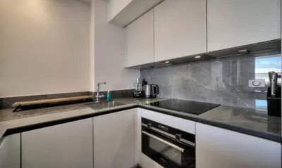 a kitchen with white cabinets and a sink at Cannes 1 bedroom apartment - M6 in Cannes