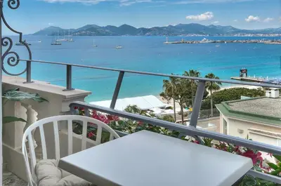 a balcony with a table and a view of the ocean at Cannes 1 bedroom apartment - M6 in Cannes
