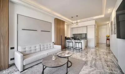 a living room with a couch and a table at Cannes 1 bedroom apartment - M6 in Cannes