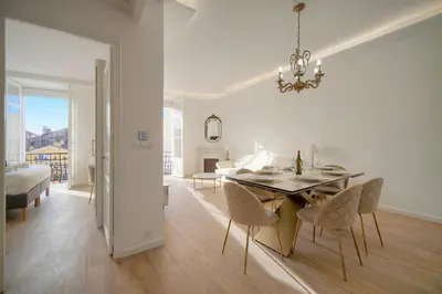 a dining room and living room with a table and chairs at Luxueux 3 chambres BALCON, CARRE D'OR- COEUR DE CANNES A3B129 in Cannes