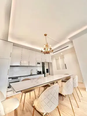 a kitchen with a dining room table and chairs at Luxueux 3 chambres BALCON, CARRE D'OR- COEUR DE CANNES A3B129 in Cannes