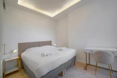 a white bedroom with a bed and a desk at Luxueux 3 chambres BALCON, CARRE D'OR- COEUR DE CANNES A3B129 in Cannes