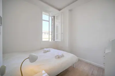 a white bedroom with a bed with towels on it at Luxueux 3 chambres BALCON, CARRE D'OR- COEUR DE CANNES A3B129 in Cannes