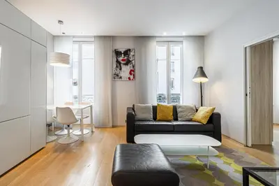 a living room with a couch and a table at LE SAINT HONORÉ idéalement situé au cœur de Cannes in Cannes