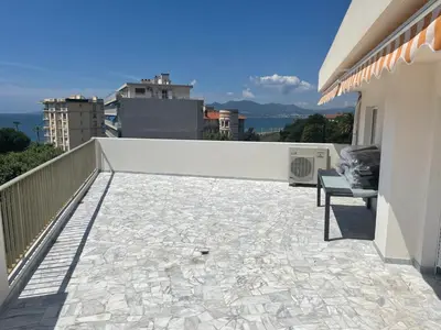 a balcony with a bench on top of a building at Modern Chic Seaview Appartement in Cannes