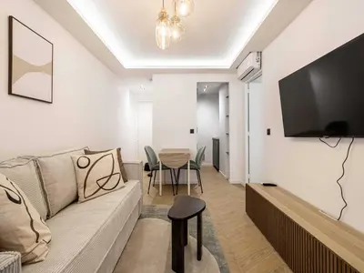 a living room with a couch and a table at Elegant Apt with balcony 1BD 4P - Croisette Cannes in Cannes
