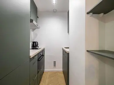 a kitchen with white walls and gray cabinets at Elegant Apt with balcony 1BD 4P - Croisette Cannes in Cannes