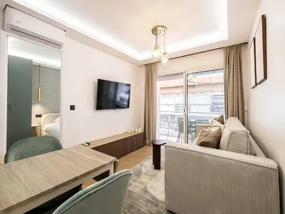 a living room with a couch and a table at Elegant Apt with balcony 1BD 4P - Croisette Cannes in Cannes