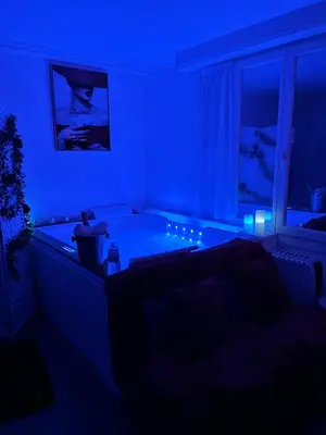 a living room with a tub in a blue room at Romantic Room - Jaccuzi Privé -Appartement Cannes in Cannes