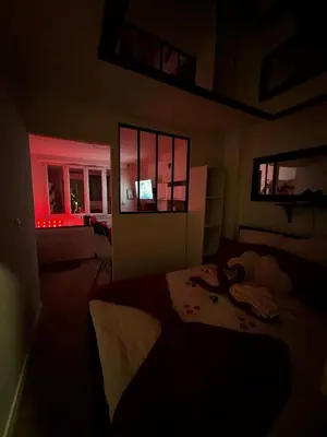 a bedroom with a bed and a window with red lights at Romantic Room - Jaccuzi Privé -Appartement Cannes in Cannes