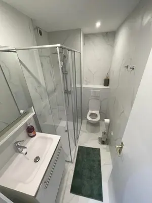a bathroom with a shower and a sink and a toilet at Mistral Seaside Studio - 200m de la Plage in Cannes