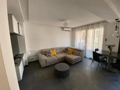 a living room with a couch and a table at Appartement MIRAMAR 5 couchages in Cannes