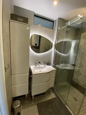 a bathroom with a sink and a shower at Appartement MIRAMAR 5 couchages in Cannes