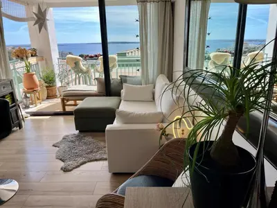 a living room with a couch and a potted plant at Cannes Passion in Cannes