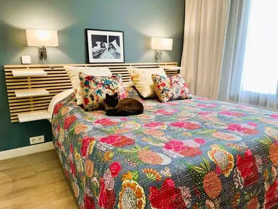 a cat laying on a bed in a bedroom at Cannes Passion in Cannes
