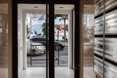 a glass door with a car in a parking lot at Luxury Croisette Sea view facing Palais in Cannes