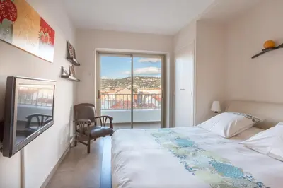 a balcony with a table and chairs and the ocean at Luxury Croisette Sea view facing Palais in Cannes