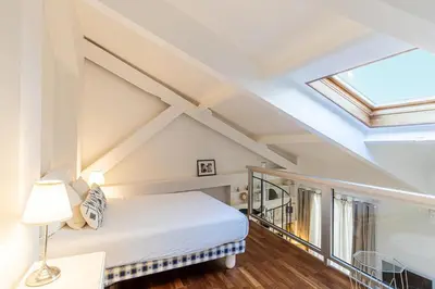 a attic bedroom with a bed and a skylight at 13 ANDRE2 - Very nice duplex apartment, 100m from La Croisette and beaches in Cannes