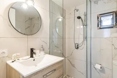 a bathroom with a sink and a shower with a mirror at 13 ANDRE2 - Very nice duplex apartment, 100m from La Croisette and beaches in Cannes