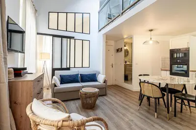 a living room with a couch and a table at 13 ANDRE2 - Very nice duplex apartment, 100m from La Croisette and beaches in Cannes