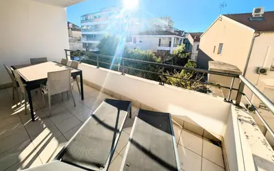 a balcony with chairs and a table on a balcony at Ref FLORIAN by Palmes dProperties in Cannes