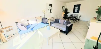 a living room with a couch and a table at Ref FLORIAN by Palmes dProperties in Cannes