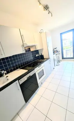 a kitchen with white cabinets and a blue tile floor at Ref FLORIAN by Palmes dProperties in Cannes