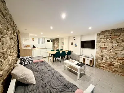 a living room with a couch and a dining room at A076 Appart 6 pers chambre et terrasse au Suquet in Cannes