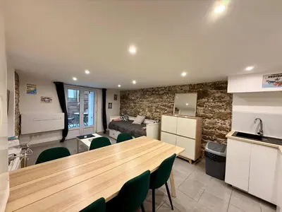a kitchen and living room with a wooden table and chairs at A076 Appart 6 pers chambre et terrasse au Suquet in Cannes